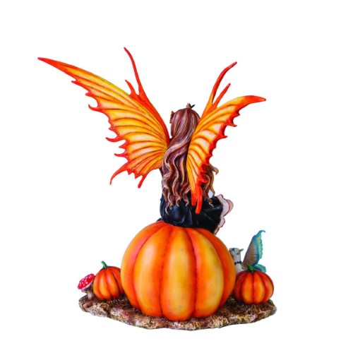 Autumn fairy figurine perched on a pumpkin, featuring a cat, glittery wings, and a detailed black and orange gown.