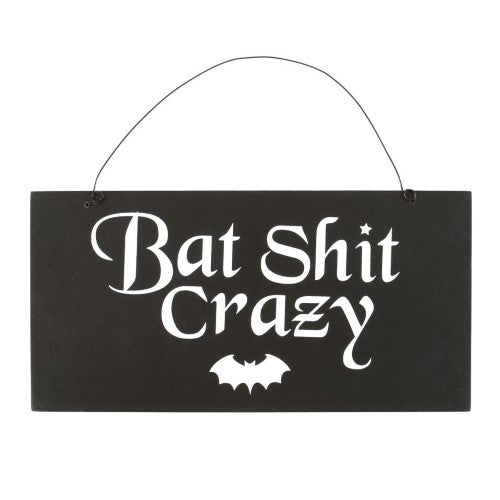 Whimsical wooden sign reading "Being normal is overrated," perfect for quirky gothic home decor enthusiasts.