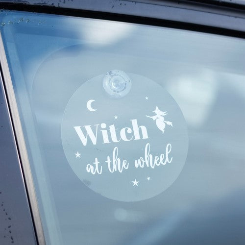 Whimsical "Witch at the Wheel" window sign with moon and stars, perfect for adding magical charm to home or car decor.