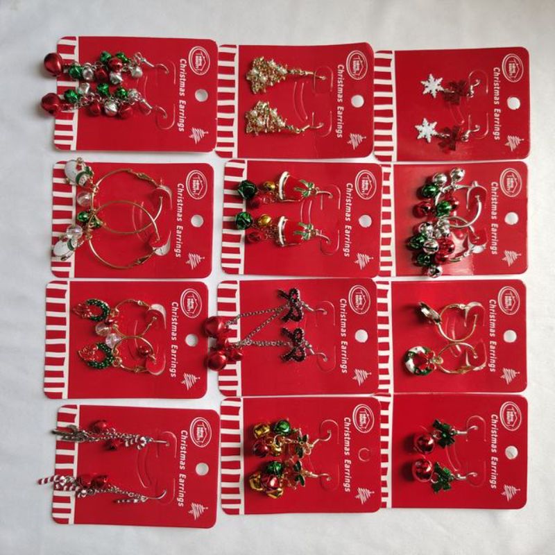 Colorful Xmas earrings set featuring 12 assorted pairs with festive designs like snowflakes, trees, and reindeer.