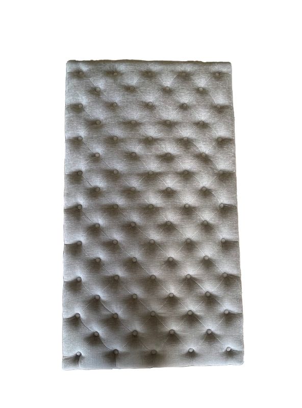 Oversized grey linen ottoman blanket box with metal handles, ideal for storage and enhancing bedroom decor.