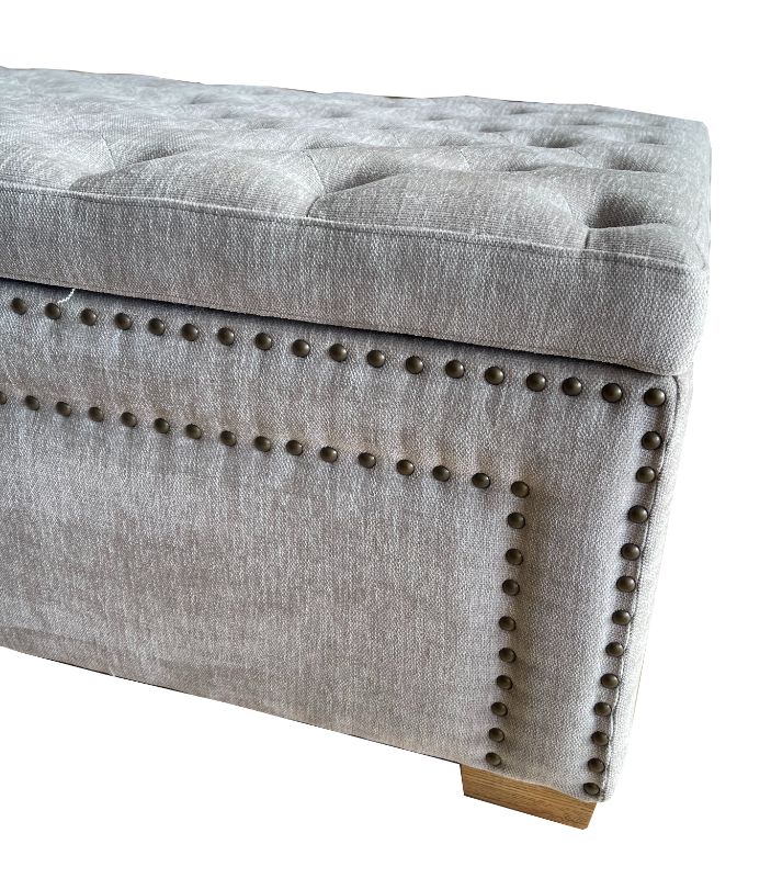 Spacious grey linen oversized ottoman with metal handles, perfect for storage and enhancing bedroom decor.
