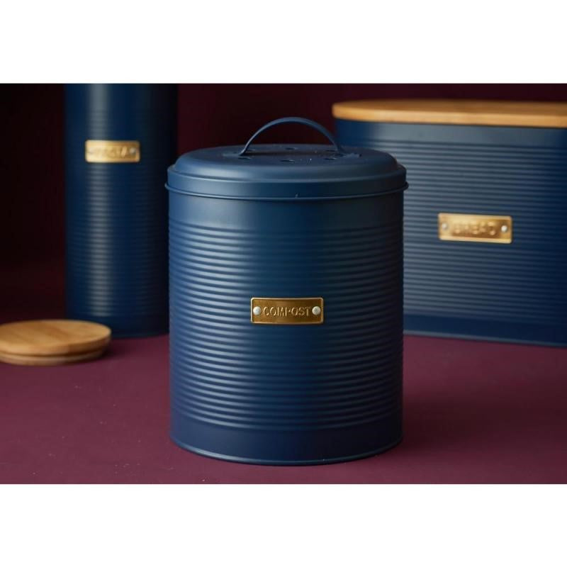 Navy compost bin with ribbed design, bamboo lid, and gold badge, perfect for stylish kitchen waste management.