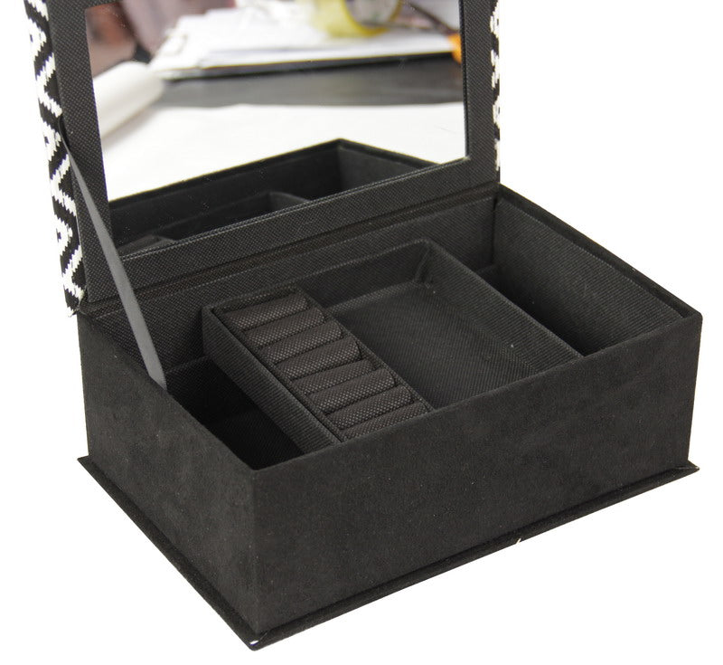 Elegant black and white jewellery box with multiple compartments for organized and tangle-free accessory storage.