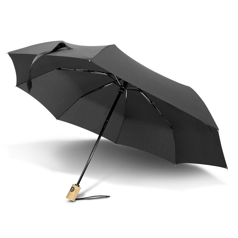 Compact black umbrella made from recycled materials, featuring eight ribs, automatic opening, and portable design.