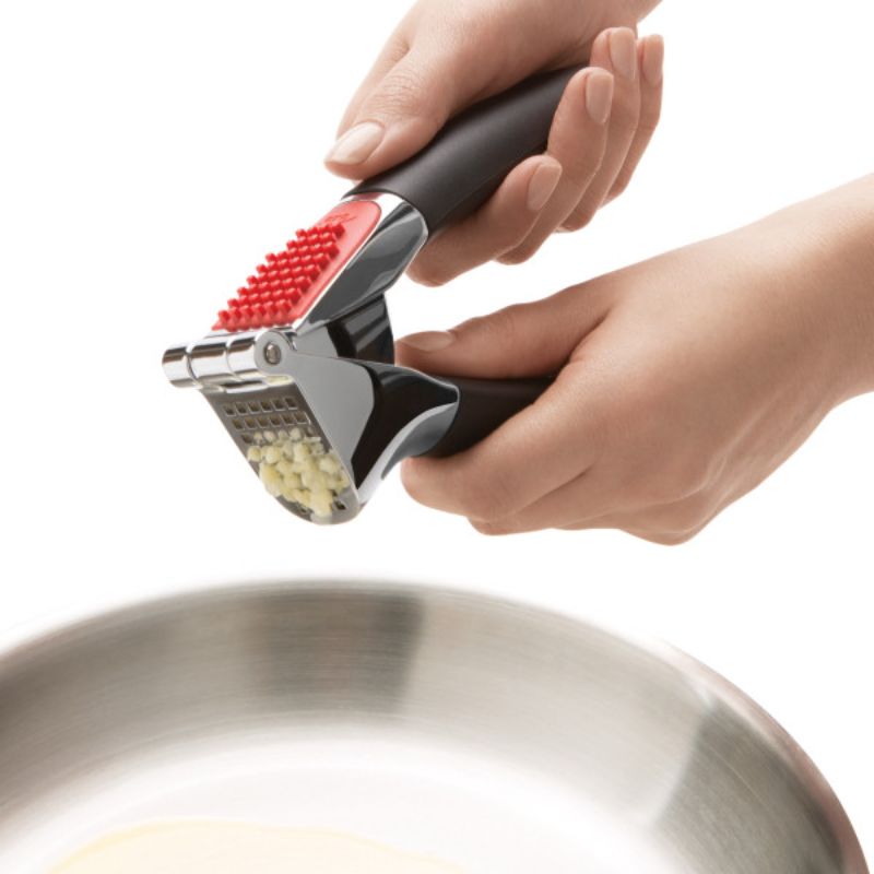 OXO Good Grips Garlic Press with comfortable handles, crushes multiple cloves, easy to clean, keeps hands mess-free.