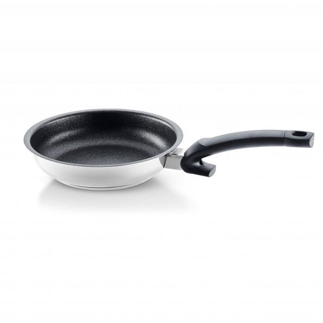 Fissler 26cm non-stick frying pan with polished stainless steel, ergonomic handle, and scratch-resistant surface for effortless cooking.