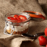 Kilner 125ml clip top glass jar with orange seal, perfect for storing food and preserving homemade jams and chutneys.