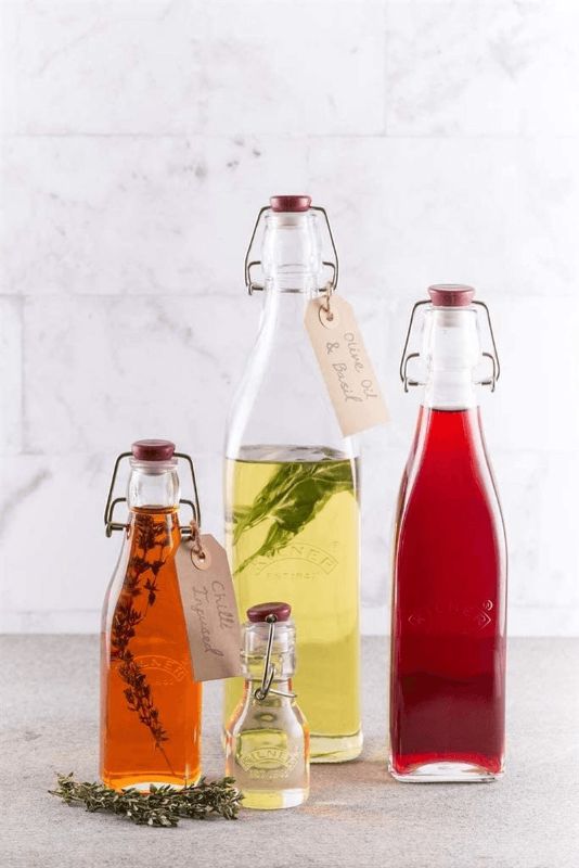 Kilner 550ml square glass bottle with clip top lid, perfect for storing sauces, oils, and decorative displays.