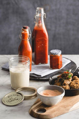 Kilner 550ml square glass bottle with vintage clip top lid, perfect for storing sauces, oils, and decorative displays.