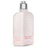 L'Occitane Cherry Blossom Shimmering Lotion in a 250ml bottle, offering hydration and a glowing iridescent finish.