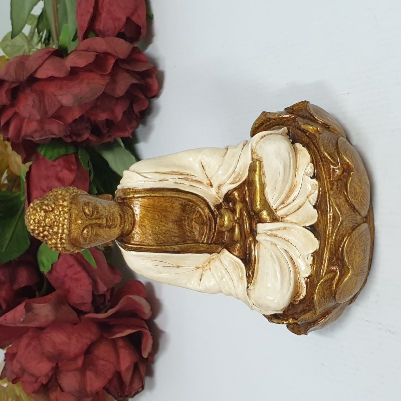 Buddha figurine seated on a lotus flower, symbolizing tranquility and mindfulness, perfect for decor and meditation spaces.