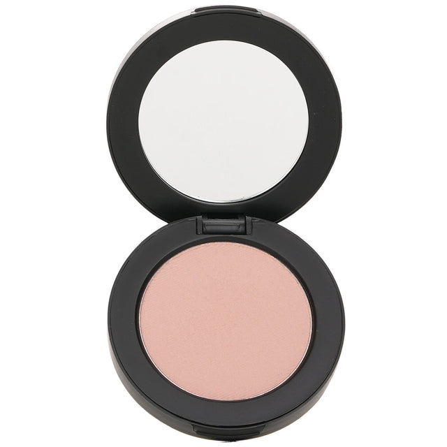 Youngblood Pressed Mineral Blush in Bashful, a sheer powder that adds color and glow, suitable for cheeks, temples, eyes, and lips.