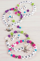 DIY bracelet kit with alphabet beads, stylish accents, charms, and elastic cord for creative kids aged 8+.