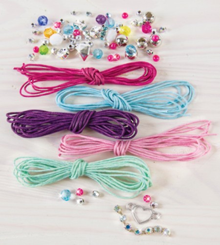 Vibrant DIY bracelet-making kit with colored cords and trendy beads for kids aged 8+, encouraging creativity and design.