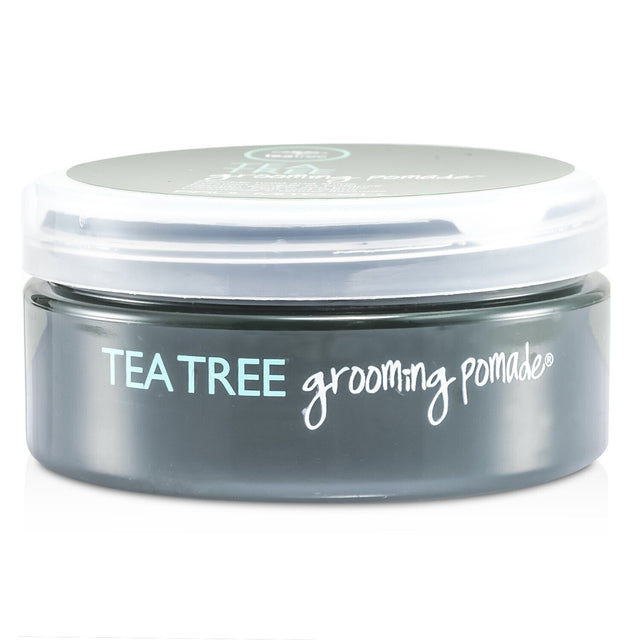 Paul Mitchell Tea Tree Grooming Pomade (85g) offers flexible hold, shine, and nourishment for wavy and curly hair.