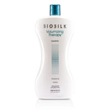 Silk-infused BioSilk Volumizing Therapy Shampoo in 1006ml offers hydration, volume, and UV protection for vibrant, healthy hair.