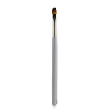 Blinc Shadow Primer Brush featuring synthetic fibers for smooth application of eyeshadow and concealer, with a durable wooden handle.