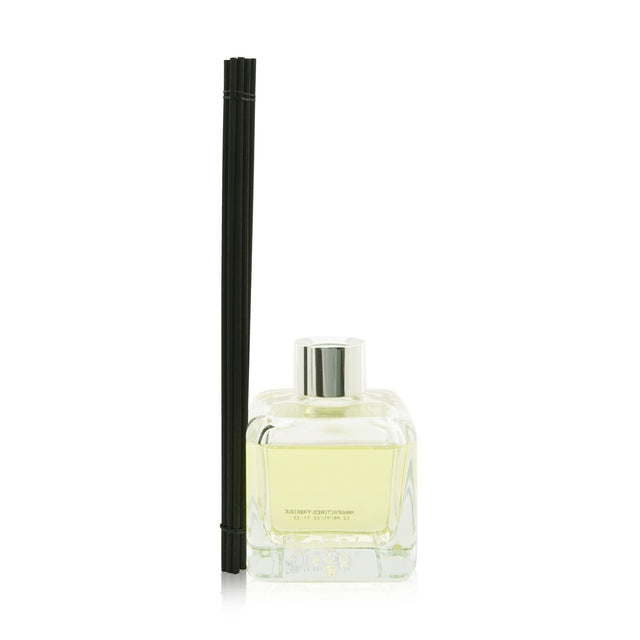 Elegant glass cube diffuser with orange and cinnamon scent, featuring engineered polymer sticks for optimal fragrance diffusion.