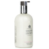 Luxurious Molton Brown body lotion with rhubarb and rose, offering deep hydration and a melt-in texture for soft, smooth skin.
