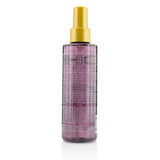 Lightweight leave-in treatment serum infused with Olive and Monoi oils for shiny, healthy, and manageable hair.