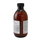Golden-toned Davines Alchemic Shampoo for vibrant, soft hair; nourishes and preserves natural and colored blonde shades.