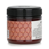 Davines Alchemic Conditioner in Copper enhances and conditions colored hair for vibrant shine and softness in a 250ml bottle.