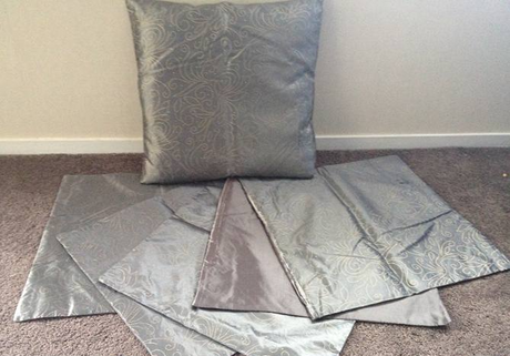 Set of 4 elegant cushion covers featuring golden leaf design on silver, perfect for enhancing home decor.