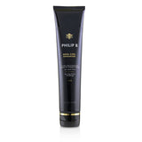 Lightweight leave-in conditioner enhances curls, tames frizz, adds shine, and nourishes hair with a sweet-woody scent.