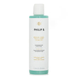 Philip B Nordic Wood Hair + Body Shampoo bottle displaying invigorating botanical ingredients for gentle cleansing.