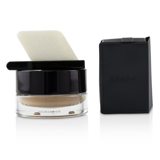 Velvety SUQQU Foundation #35, 30g, offers medium to full coverage with a dewy finish, enhancing complexion and promoting skin wellness.