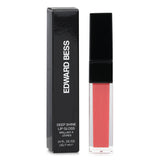 Luxurious Edward Bess lip gloss in #26 Lover's Desire, offering vibrant color and moisture for a seductive, glossy pout.