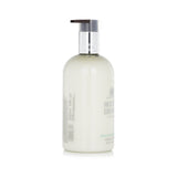 Luxurious Molton Brown hand lotion featuring clary sage, basil, and bergamot for soft, hydrated hands in a 300ml bottle.