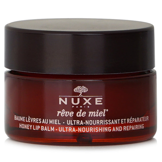 Nuxe Reve De Miel Honey Lip Balm in random packaging, nourishing very dry lips with honey and botanical oils, 15g.