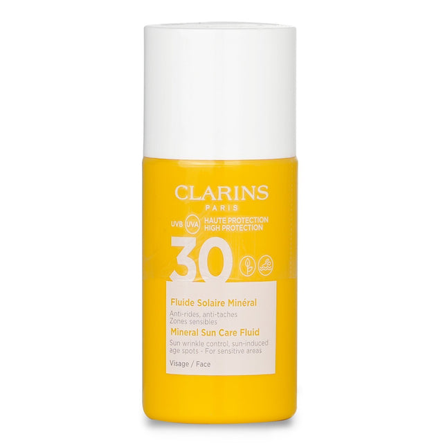Clarins Mineral Sun Care Fluid SPF 30 for face, tinted, waterproof, and designed for sensitive areas, in a 30ml portable bottle.