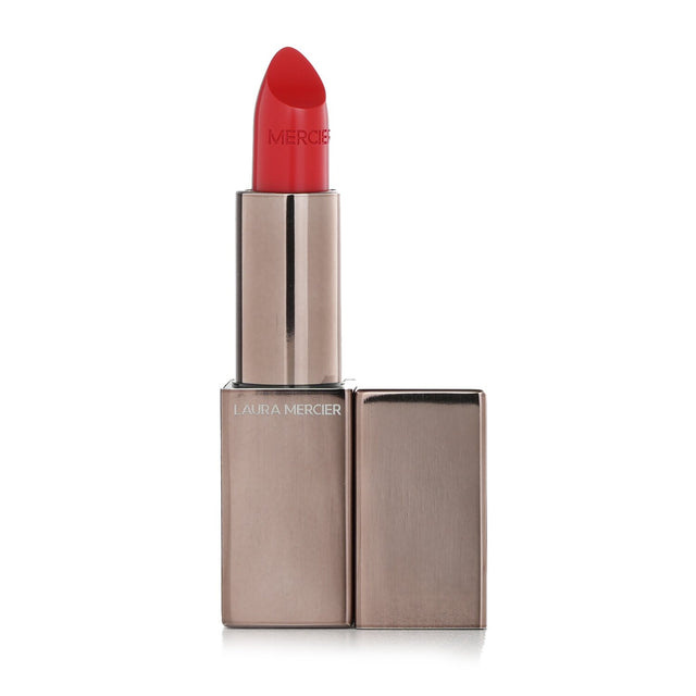 Laura Mercier's #Rouge Electrique silky orange-red lipstick, offering vibrant color and hydration with a weightless feel.