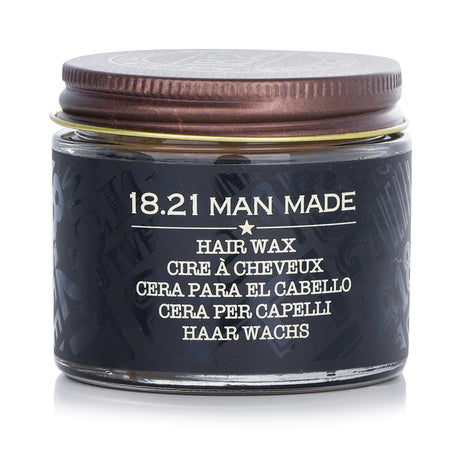 18.21 Man Made Wax in Sweet Tobacco scent, offering high hold and satin finish for versatile styling of hair and beards.