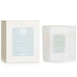 Luxurious hexagonal candle in a soft white glass, featuring oceanic and citrus scents; perfect for home decor and gifting.