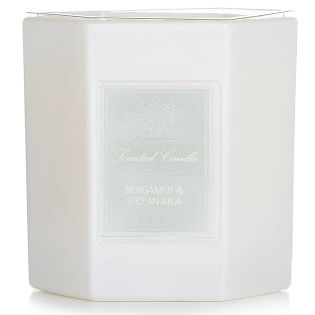 Elegant hexagonal candle in white glass, blending bergamot, ocean tones, and floral scents; 60-hour burn time.