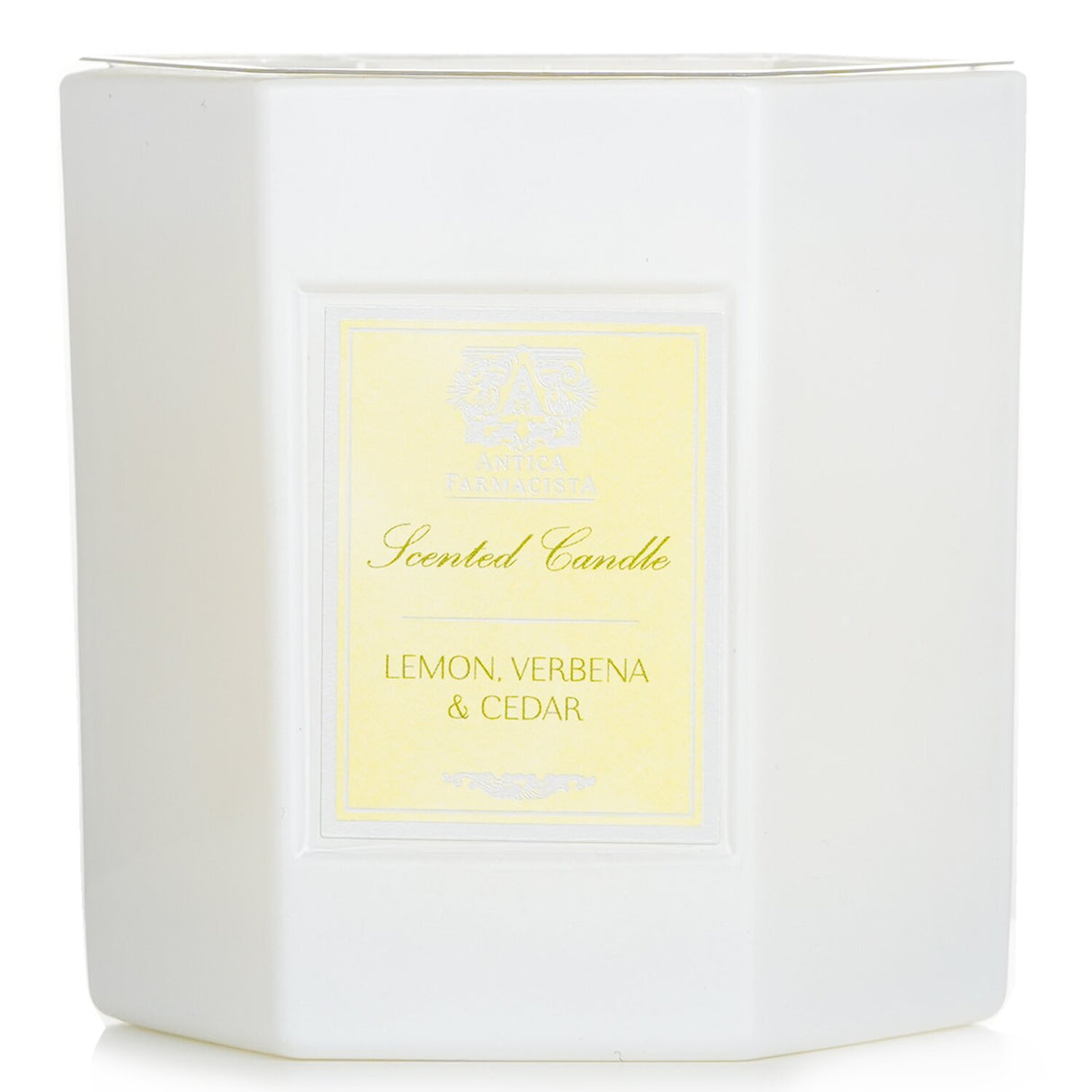 Antica Farmacista hexagonal candle in white glass, featuring lemon, verbena & cedar scent with 60-hour burn time.