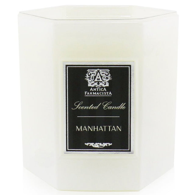 Antica Farmacista Manhattan Candle in a soft white glass, offering 60 hours of luxurious scent with vibrant notes.