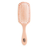 Eco-friendly Wet Brush with coconut oil for shine, featuring soft bristles and biodegradable handle for healthy hair care.