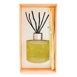 Frosted glass diffuser with natural willow stems, releasing Aroma Love fragrance of ylang-ylang and patchouli for 6-8 weeks.