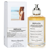 Maison Margiela Replica Beach Walk Eau De Toilette Spray, 100ml, captures summer with zesty citrus and creamy coconut notes.