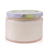 "Voluspa Panjore Lychee Petite Jar Candle features a vibrant container, tropical scent, and natural wax for a clean burn."