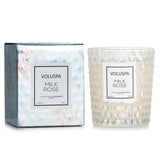 Voluspa Milk Rose Candle in a geometric glass container, featuring a romantic floral scent and 40-hour burn time.