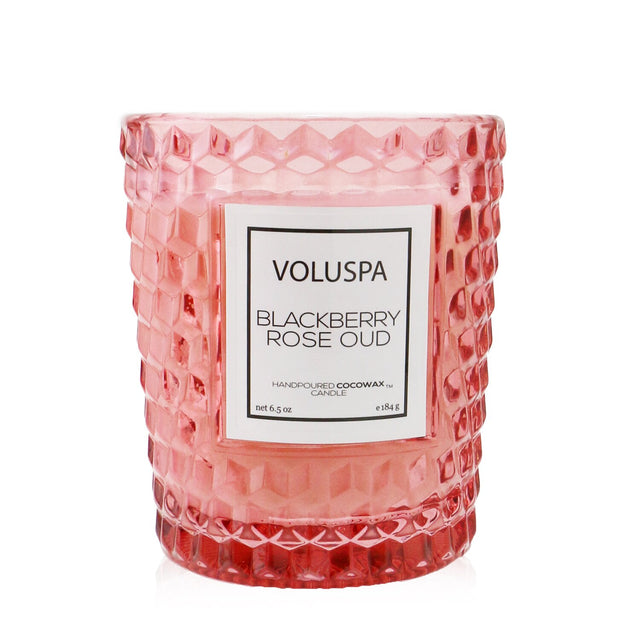 Elegant Voluspa Blackberry Rose Oud candle in a geometric glass container with a romantic floral fragrance and 40-hour burn time.