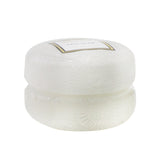 Elegant Voluspa Macaron Candle in Mokara, 51g, with orchid and lily scent, housed in a chic geometric glass container.
