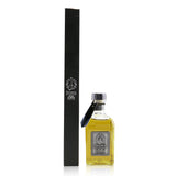 Elegant glass bottle diffuser with black reeds, releasing captivating aromas for a serene home atmosphere.