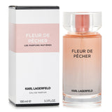 Lagerfeld Fleur De Pecher Eau De Parfum in a sleek peach-tone bottle, featuring floral fruity notes for elegant daytime wear.